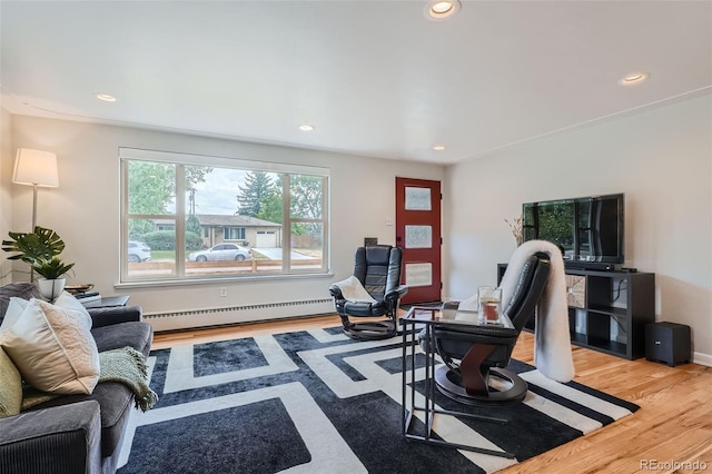 living room with wood-type flooring and baseboard heating