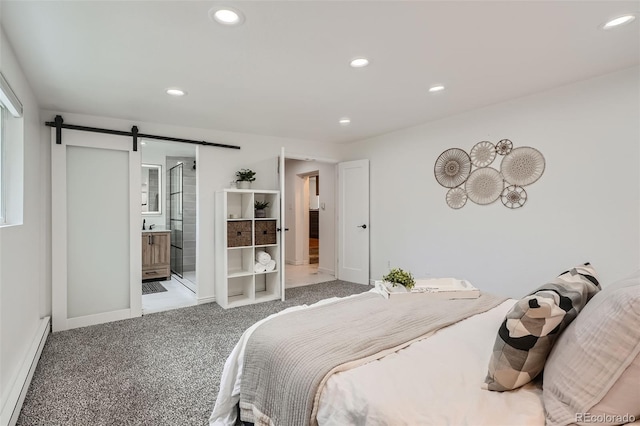 bedroom featuring a baseboard radiator, a barn door, carpet flooring, and ensuite bathroom