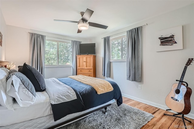 bedroom featuring light hardwood / wood-style flooring and ceiling fan