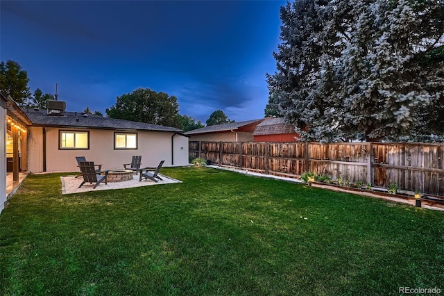 yard at dusk with a fire pit and a patio