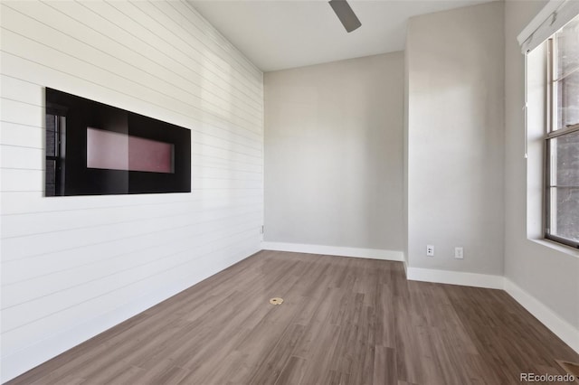 empty room with wood-type flooring and ceiling fan