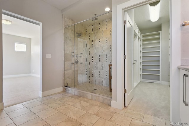 bathroom with a shower with shower door and tile patterned flooring