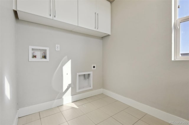 washroom with light tile patterned flooring, cabinets, washer hookup, and hookup for an electric dryer