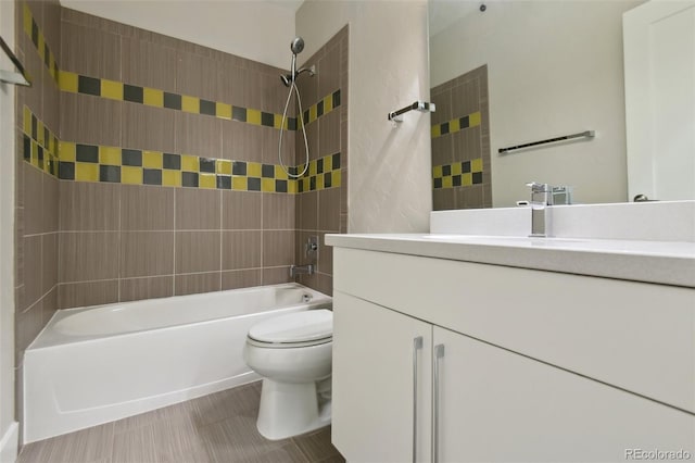 full bathroom with vanity, tile patterned flooring, tiled shower / bath combo, and toilet