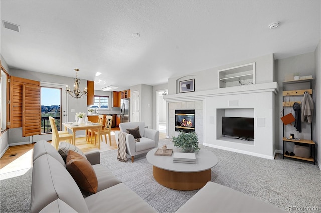 7511 S Sicily Way, Aurora, CO 80016 - living room featuring a chandelier, a tile fireplace, baseboards, and built in features