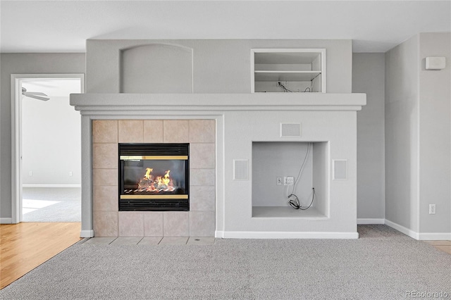 7511 S Sicily Way, Aurora, CO 80016 - detailed view of carpet floors, a tiled fireplace, baseboards, and built in features
