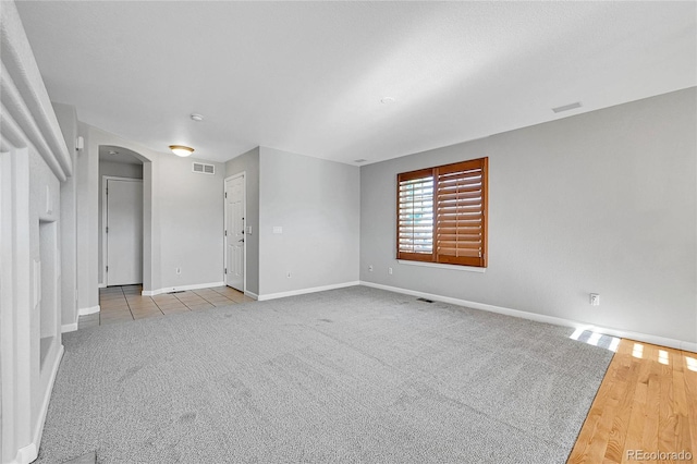 7511 S Sicily Way, Aurora, CO 80016 - unfurnished room featuring arched walkways, baseboards, and carpet