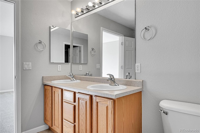 7511 S Sicily Way, Aurora, CO 80016 - bathroom with toilet, double vanity, and a textured wall