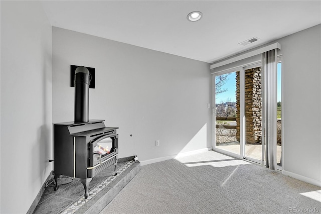 7511 S Sicily Way, Aurora, CO 80016 - carpeted living room with a wood stove, baseboards, and recessed lighting
