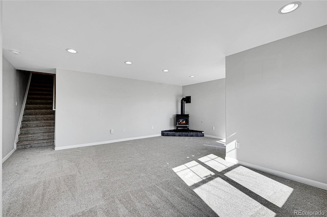 7511 S Sicily Way, Aurora, CO 80016 - unfurnished living room with a wood stove, recessed lighting, carpet, stairs, and baseboards
