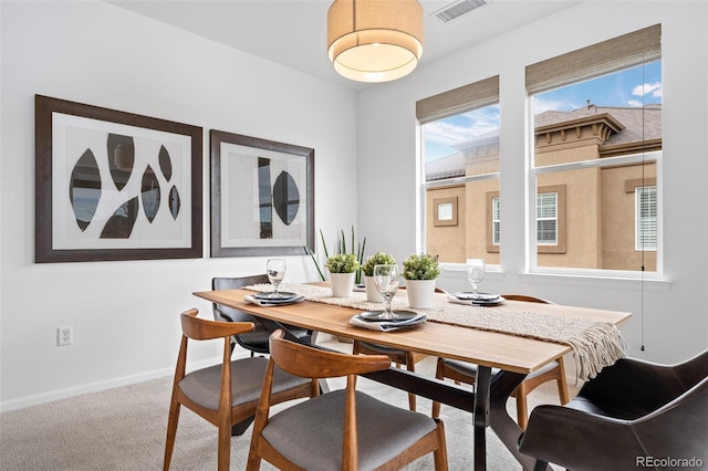 carpeted dining space featuring plenty of natural light