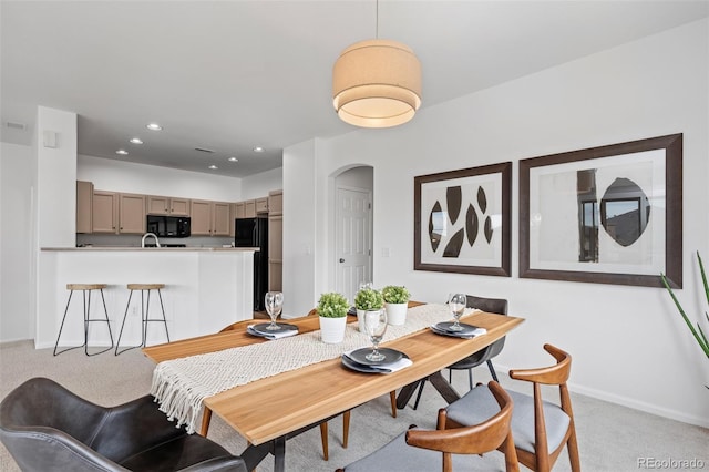 dining space with light carpet