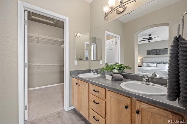 bathroom featuring ceiling fan and vanity