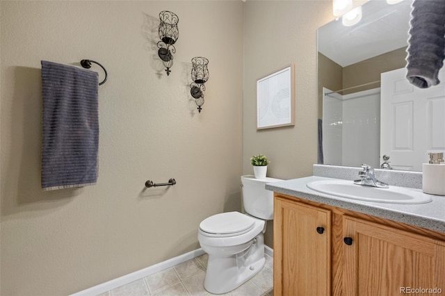 bathroom with tile patterned floors, toilet, vanity, and walk in shower