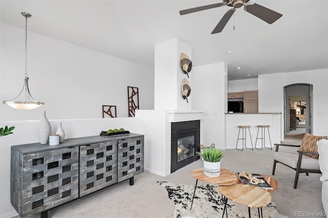 carpeted living room featuring ceiling fan