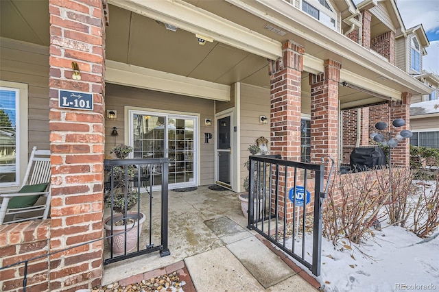 view of snow covered property entrance