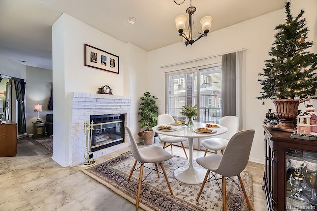 dining room featuring a fireplace and a chandelier