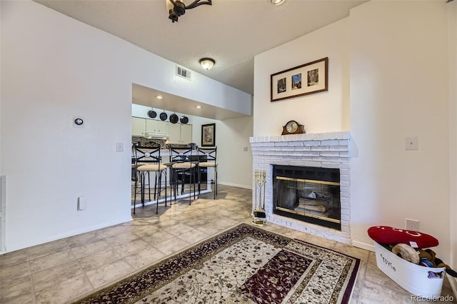 living room featuring a fireplace and a textured ceiling