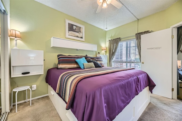 carpeted bedroom with a textured ceiling and ceiling fan