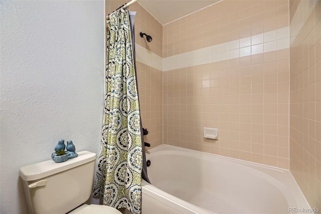 bathroom with shower / bath combo and toilet