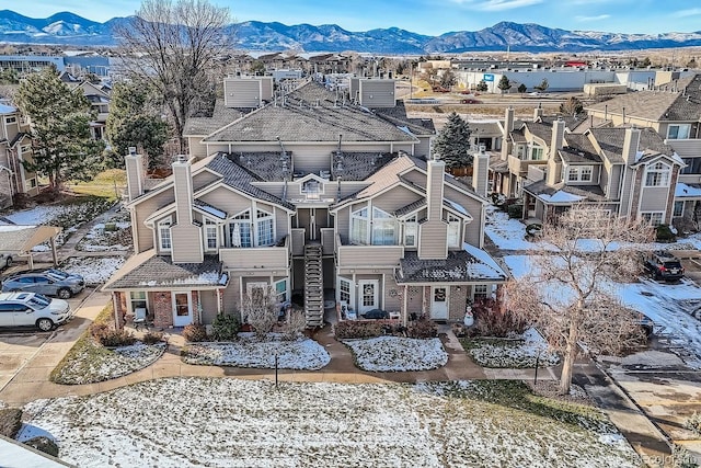 snowy aerial view featuring a mountain view