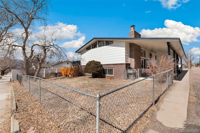 1512 E Monument St, Colorado Springs, CO 80909 - view of property exterior featuring a chimney and brick siding