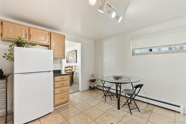 1512 E Monument St, Colorado Springs, CO 80909 - kitchen with freestanding refrigerator, light brown cabinetry, light tile patterned floors, and dark countertops