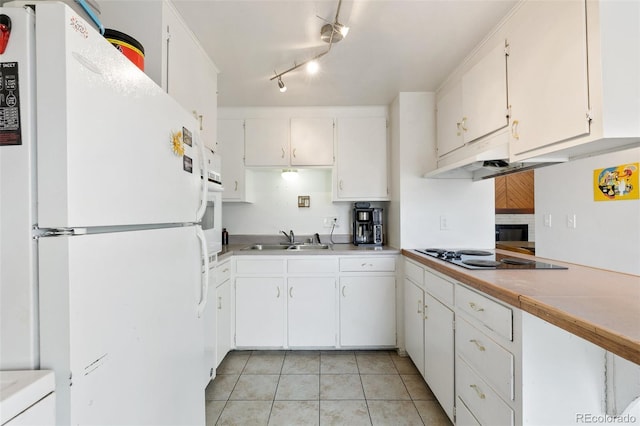 1512 E Monument St, Colorado Springs, CO 80909 - kitchen featuring white appliances, a sink, light tile patterned flooring, and white cabinets