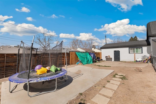 1512 E Monument St, Colorado Springs, CO 80909 - fenced backyard with a trampoline and a patio