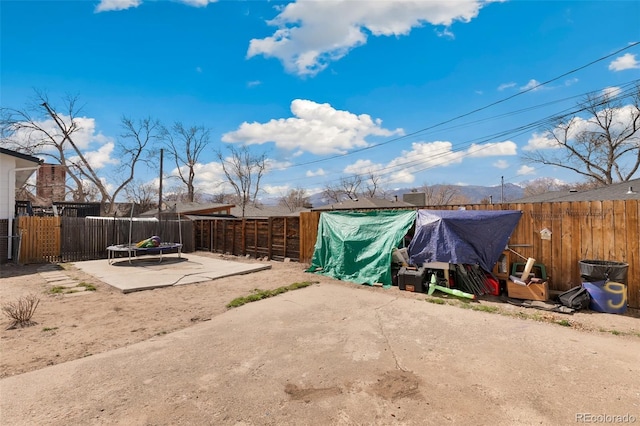 1512 E Monument St, Colorado Springs, CO 80909 - fenced backyard featuring a trampoline and a patio