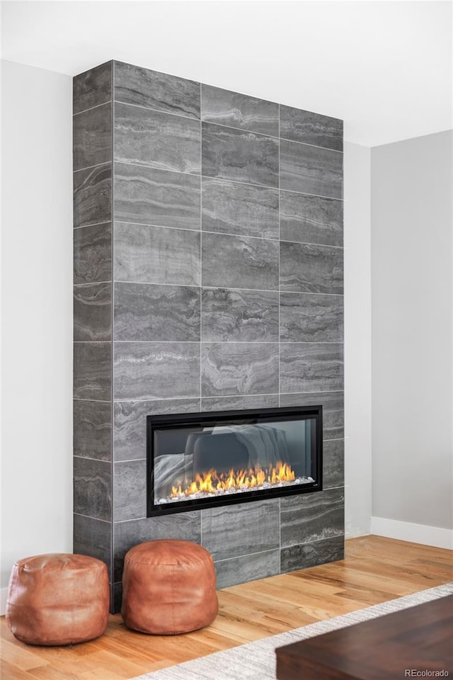 1541 Glencoe St, Denver, CO 80220 - detailed view of a tile fireplace, wood finished floors, and baseboards