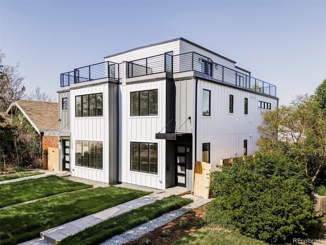 1541 Glencoe St, Denver, CO 80220 - view of home's exterior featuring a balcony, board and batten siding, and a yard
