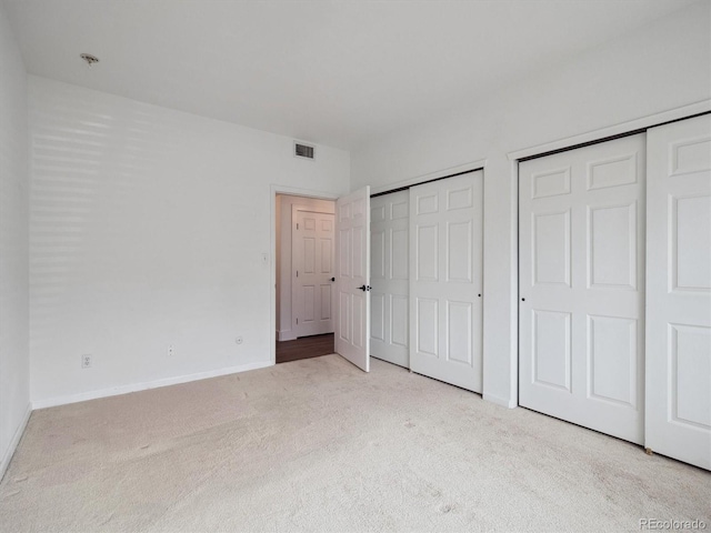 3855 Canyon Ranch Rd Unit 104, Highlands Ranch, CO 80126 - unfurnished bedroom featuring multiple closets, carpet, and baseboards