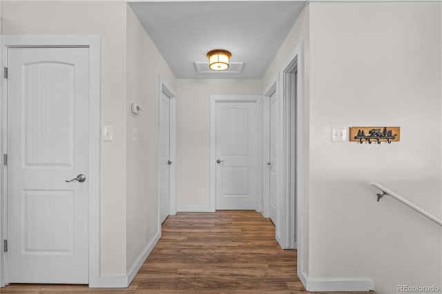 hall featuring wood finished floors and baseboards