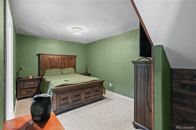 carpeted bedroom with baseboards and a textured wall