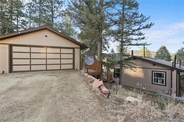 view of side of property with a detached garage and an outdoor structure