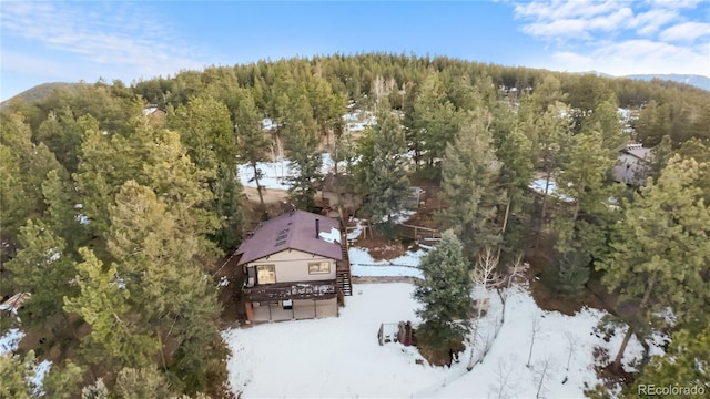 birds eye view of property with a wooded view