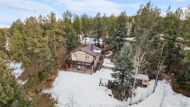 birds eye view of property with a view of trees