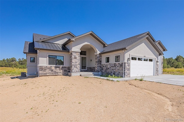 view of front of house featuring central air condition unit and a garage