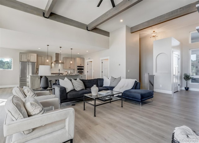 living room with beam ceiling and light wood-type flooring