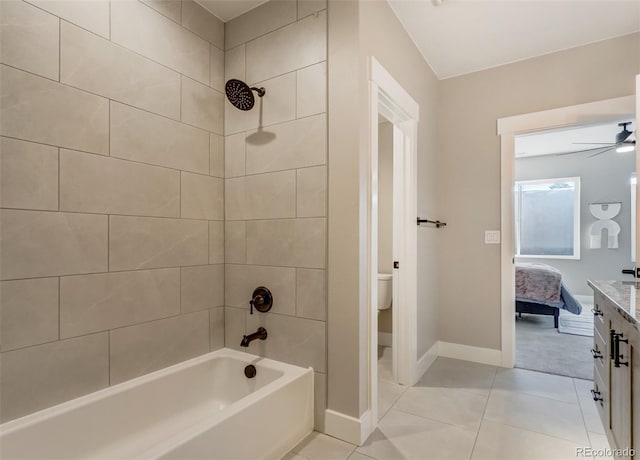 full bathroom featuring vanity, tiled shower / bath combo, tile patterned floors, and toilet