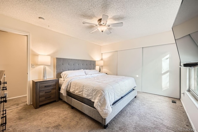 4049 S Nucla Way, Aurora, CO 80013 - bedroom with light carpet, a textured ceiling, a closet, and a ceiling fan