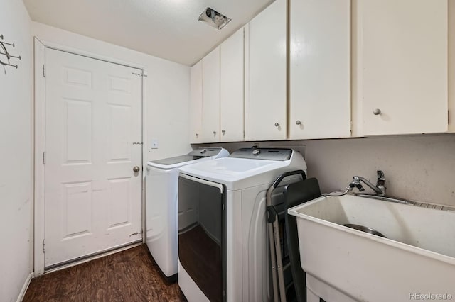 4049 S Nucla Way, Aurora, CO 80013 - washroom featuring cabinet space, washing machine and dryer, and dark wood-style flooring