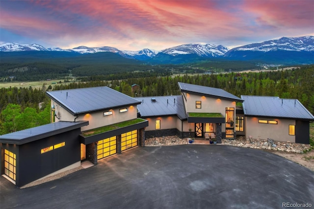 view of front of home with a garage and a mountain view