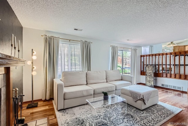 6057 S Pierson St, Littleton, CO 80127 - living room featuring wood finished floors, a textured ceiling, and baseboards