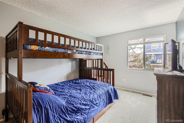 6057 S Pierson St, Littleton, CO 80127 - bedroom featuring carpet flooring, a textured ceiling, and baseboards