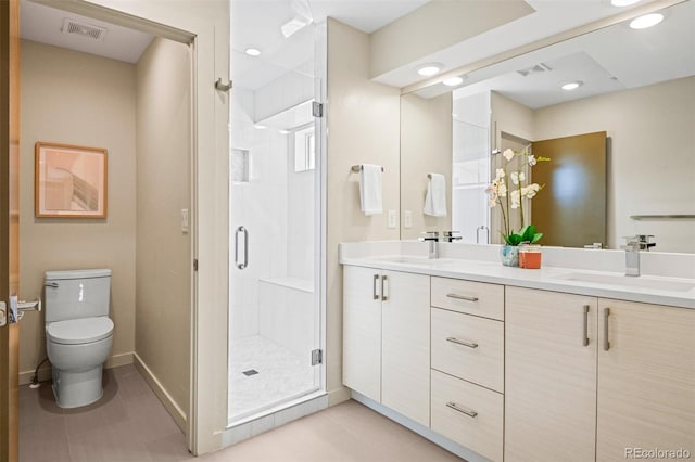 bathroom with tile patterned flooring, vanity, toilet, and an enclosed shower