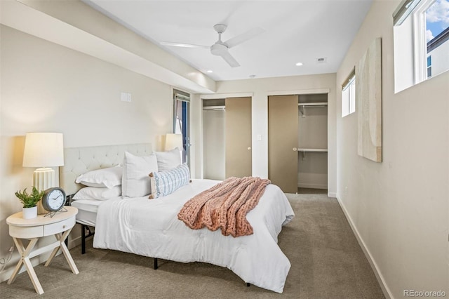 bedroom with carpet, two closets, and ceiling fan