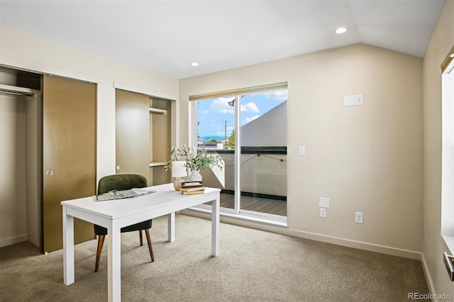 carpeted home office with lofted ceiling