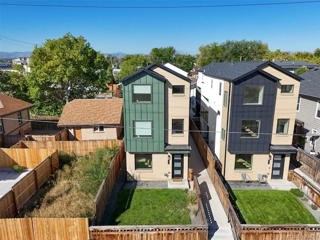 view of front of property with a patio and a front lawn